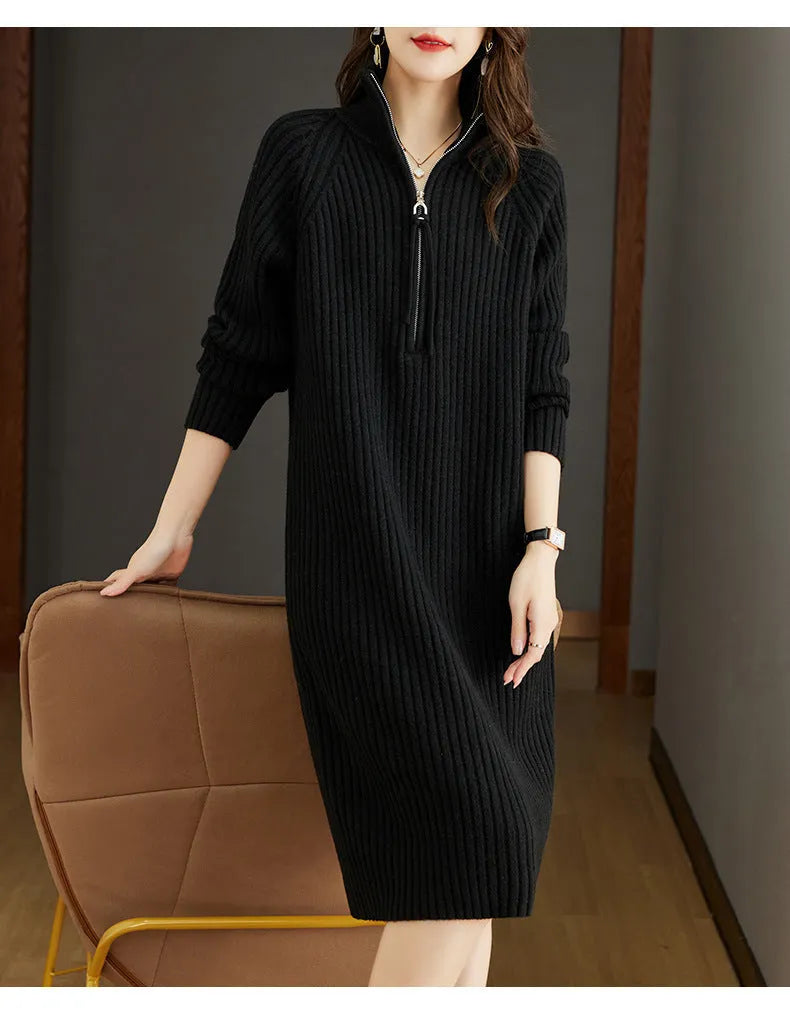 Beige half-zip woolen skirt with stand collar and long sleeves in a loose, straight dress cut.