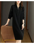 Beige half-zip woolen skirt with stand collar and long sleeves in a loose, straight dress cut.