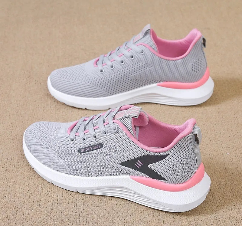 Women's low top casual running shoes in beige with mesh upper, lace-up front, round toe, and soft PVC sole
