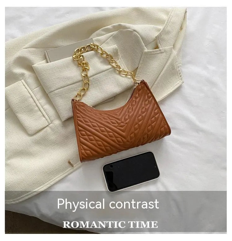 A women's black pleated chain baguette shoulder bag with a vertical square shape and an adjustable strap.