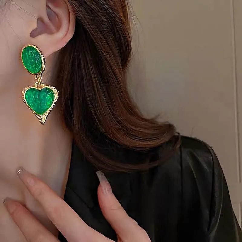 Pleated oval love heart stud earrings in alloy, showing purple, red, green, and yellow with white colour variations.