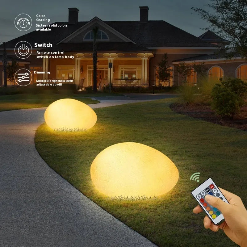 Outdoor pebble light in stone shape with IP65 waterproof rating, available in 26-48cm sizes for garden path, solar or rechargeable power options