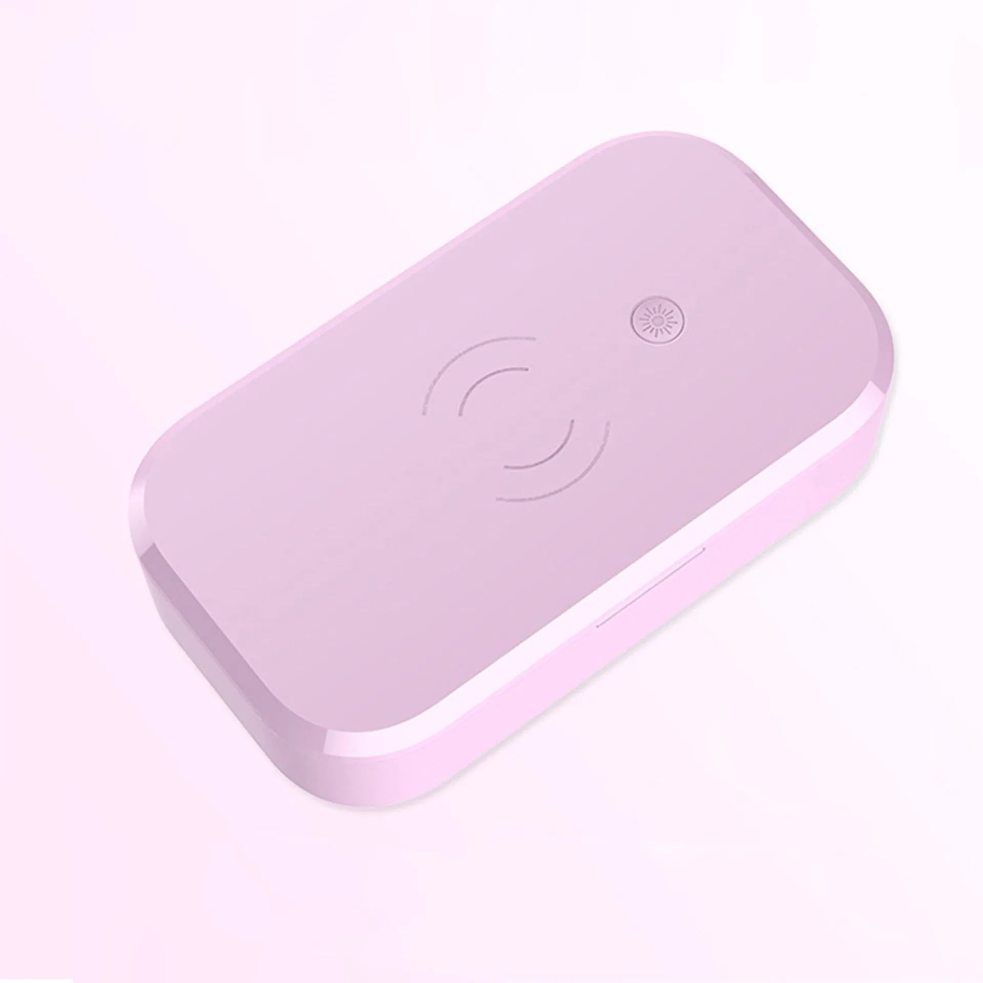 White ultraviolet disinfection box with wireless charging pad for mobile phones and nail tools.