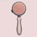Green and pink double-sided cat grooming brush with release button and flea comb