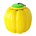 Orange plastic pumpkin-shaped dog chew toy with squeaker on a green background
