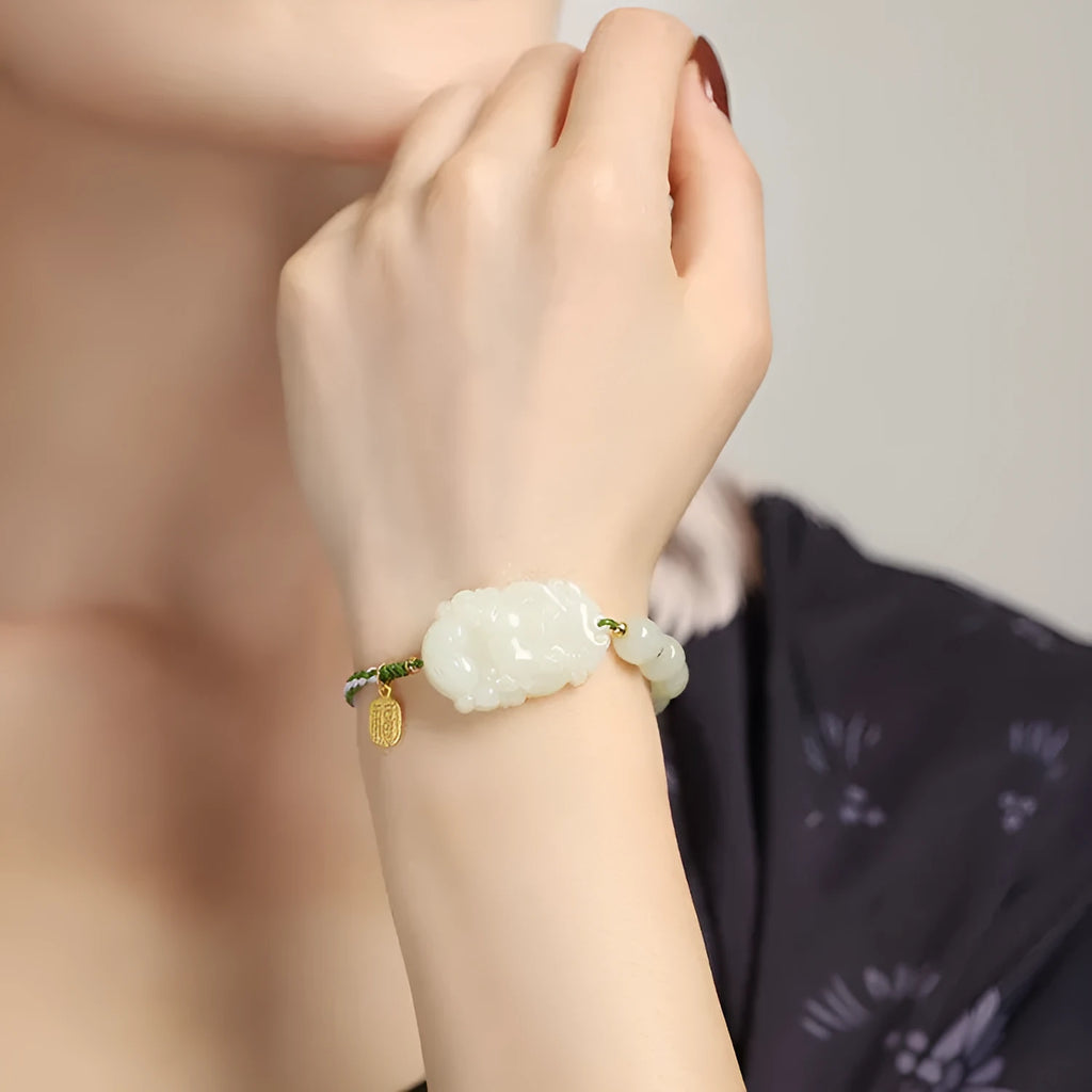 Year of the Rabbit Hetian jade charm bracelet with S925 silver detailing on a red cotton rope.