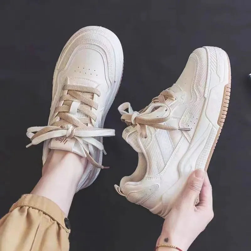 Women's pink low-top sneaker with imitation leather upper and rubber sole on a plain background.