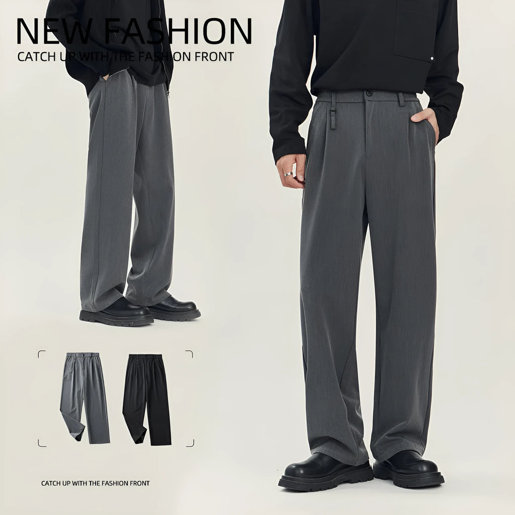 Man wearing loose straight-leg black business casual trousers made from polyester blend fabric.