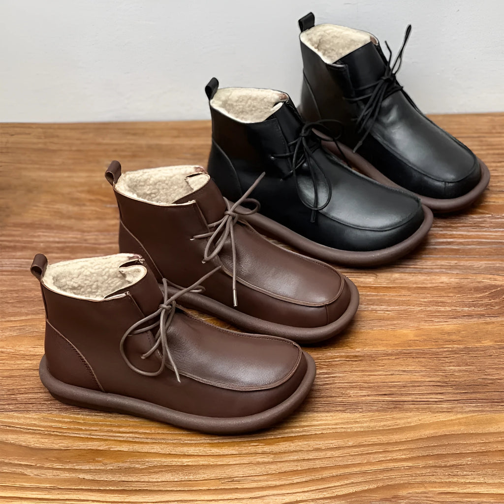 Women's black cowhide ankle boots with flat heel and round toe, showing 9cm sock height