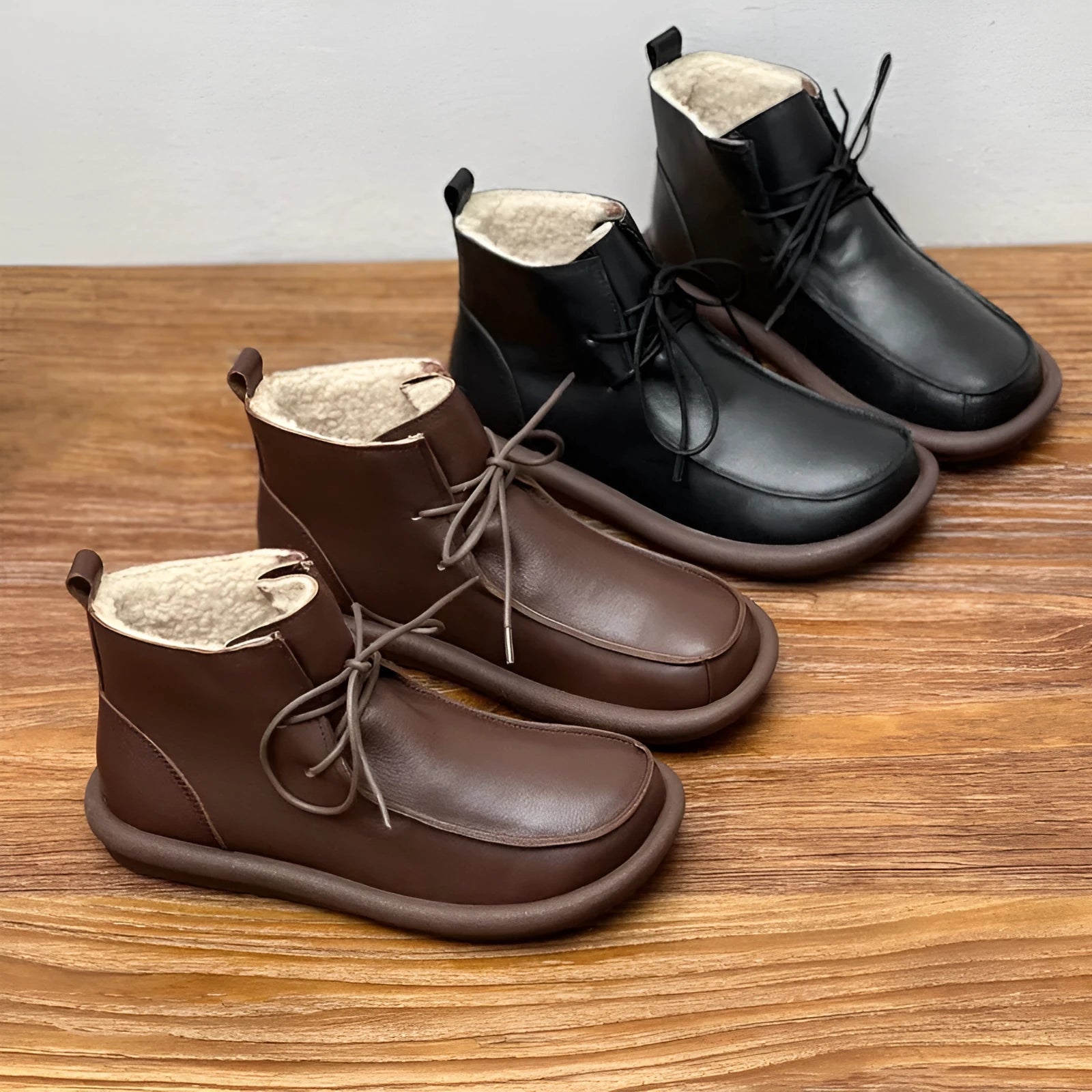 Women's black cowhide ankle boots with flat heel and round toe, showing 9cm sock height
