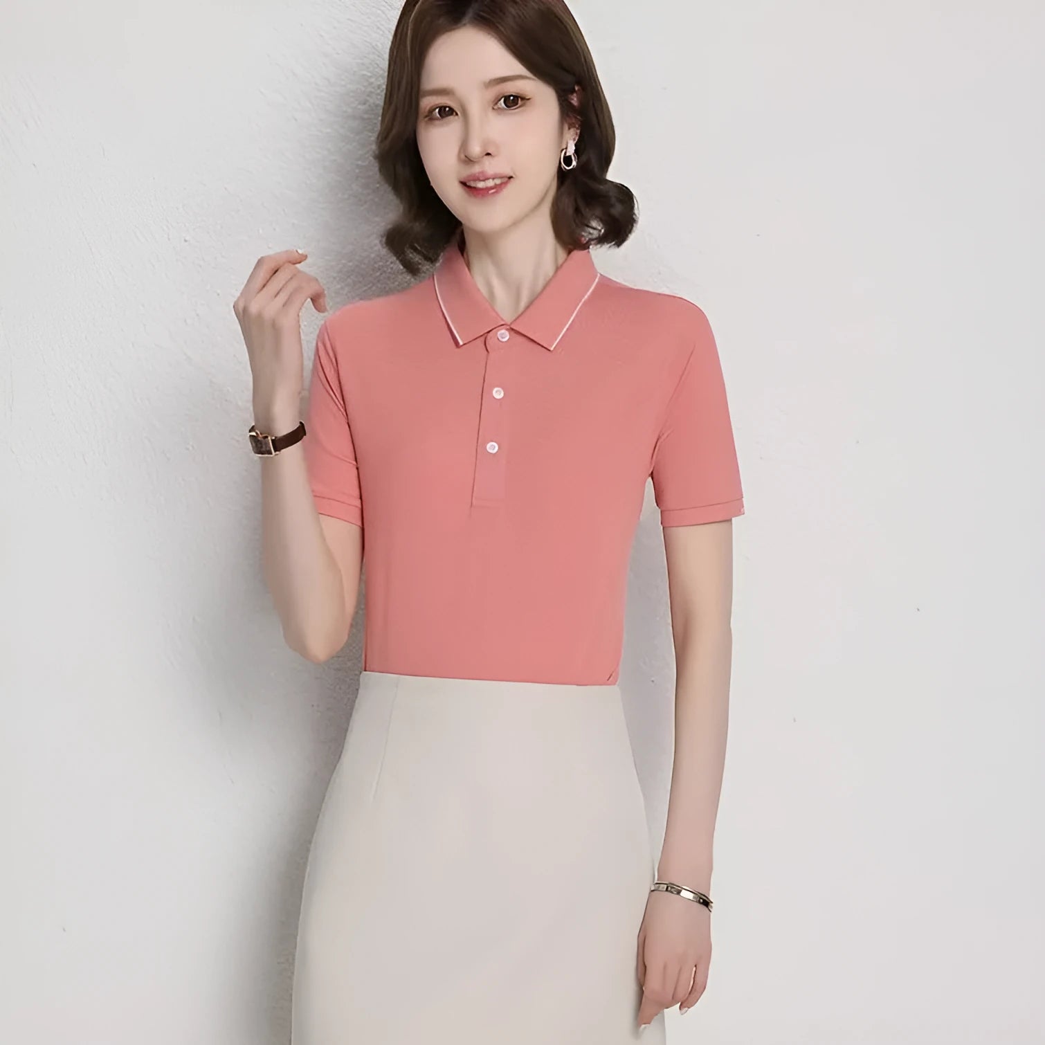 Man wearing a loose fit apricot coloured short sleeve cotton blend polo shirt.