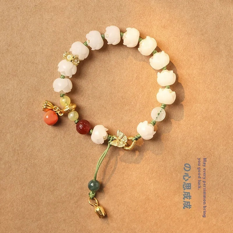 Hand-woven white jade bodhi bracelet showing pumpkin and lotus beads on adjustable open rope