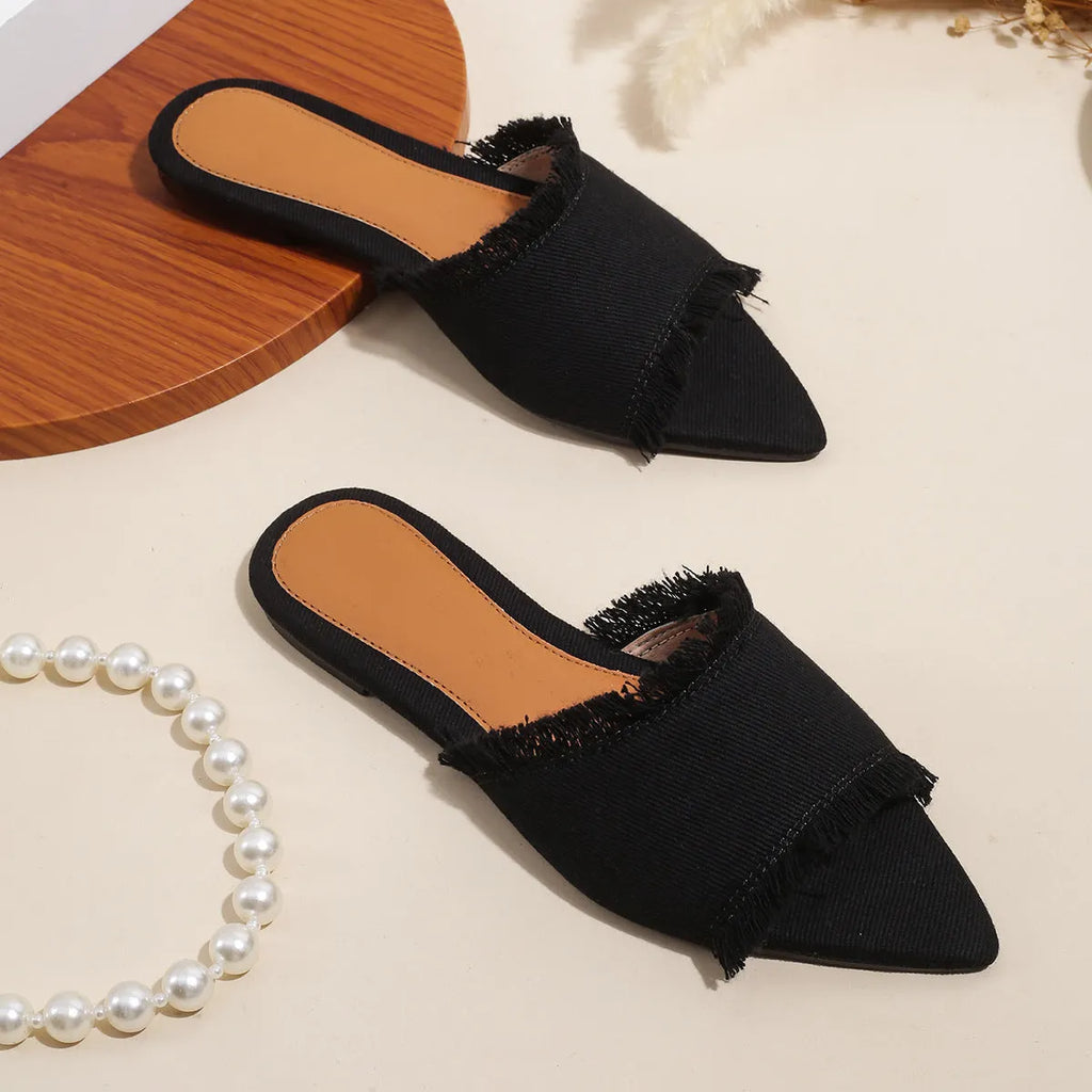 Women's denim slippers with leather lining, tassel detail, and a lightweight PVC sole.
