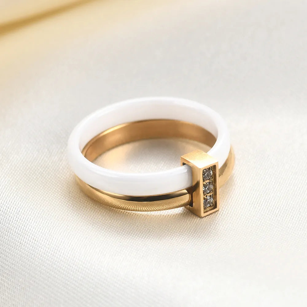 Glossy black ceramic women's ring with round zirconium stones on a geometric 6mm band.