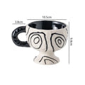 Hand-pinched irregular shaped ceramic mug in a solid colour, showing its unique handmade form.
