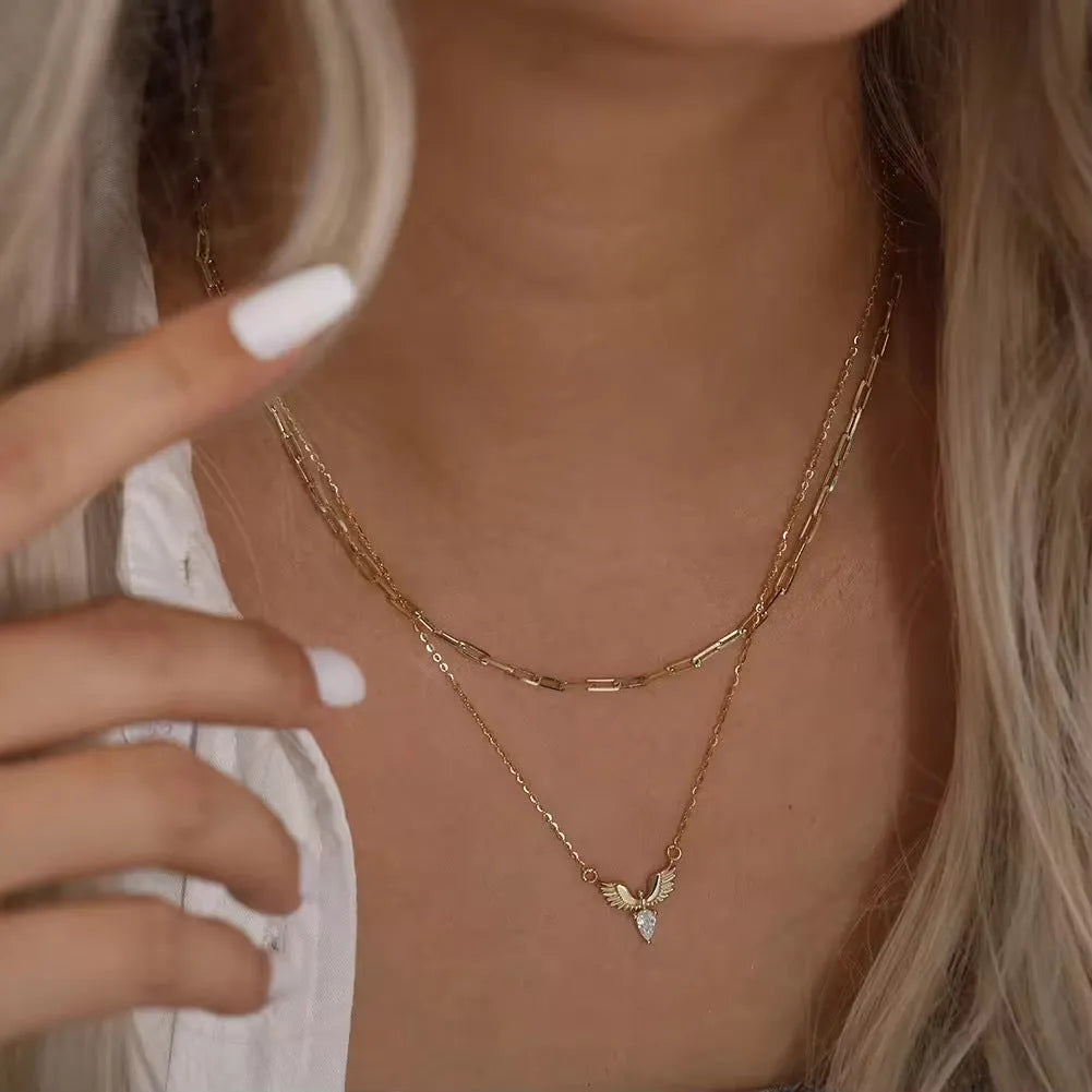 Close-up of a women's silver necklace with an eagle pendant on an adjustable O-ring chain.