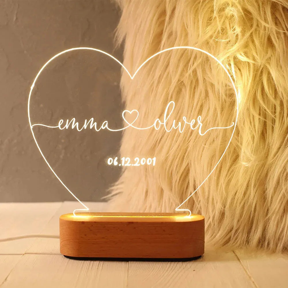 Custom transparent acrylic LED night light etched with personal names and date.