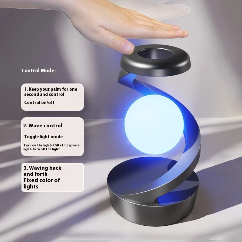 Rotating moon desk lamp with wireless charger in grey on a bedside table