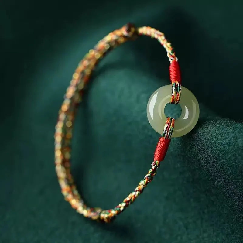 Colourful woven rope bracelet with peace buckle closure on wrist
