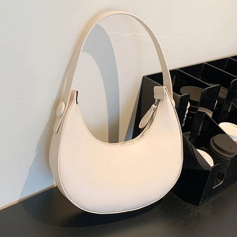 Women's retro brown PU dumpling shape shoulder bag with a front pocket shown.