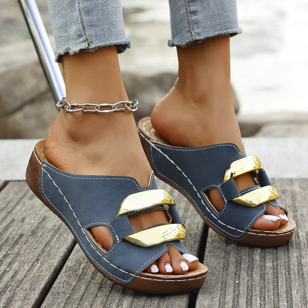 Roman style platform flip-flop sandals in a solid colour with a flat heel and metal detail.