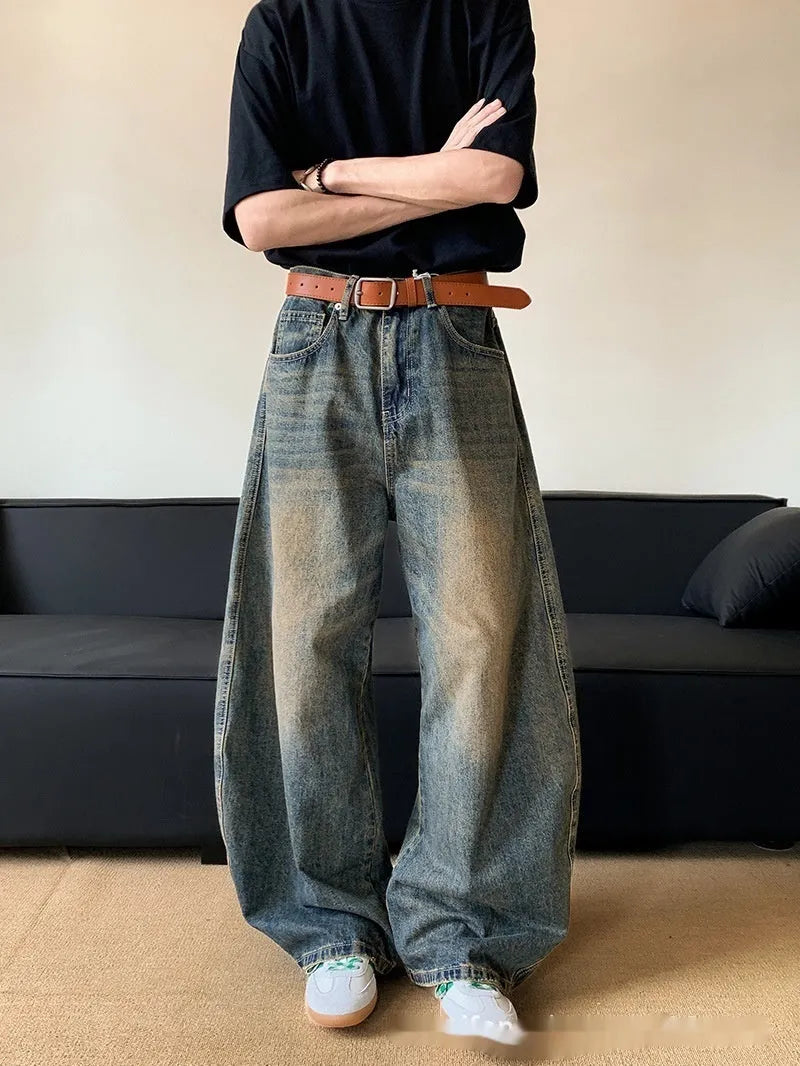 Retro blue distressed men's jeans with wide leg fit and micro elastic cotton blend fabric
