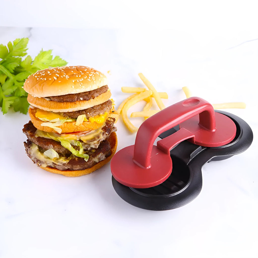 Black and red round burger press mould with oil paper liners on a kitchen counter.