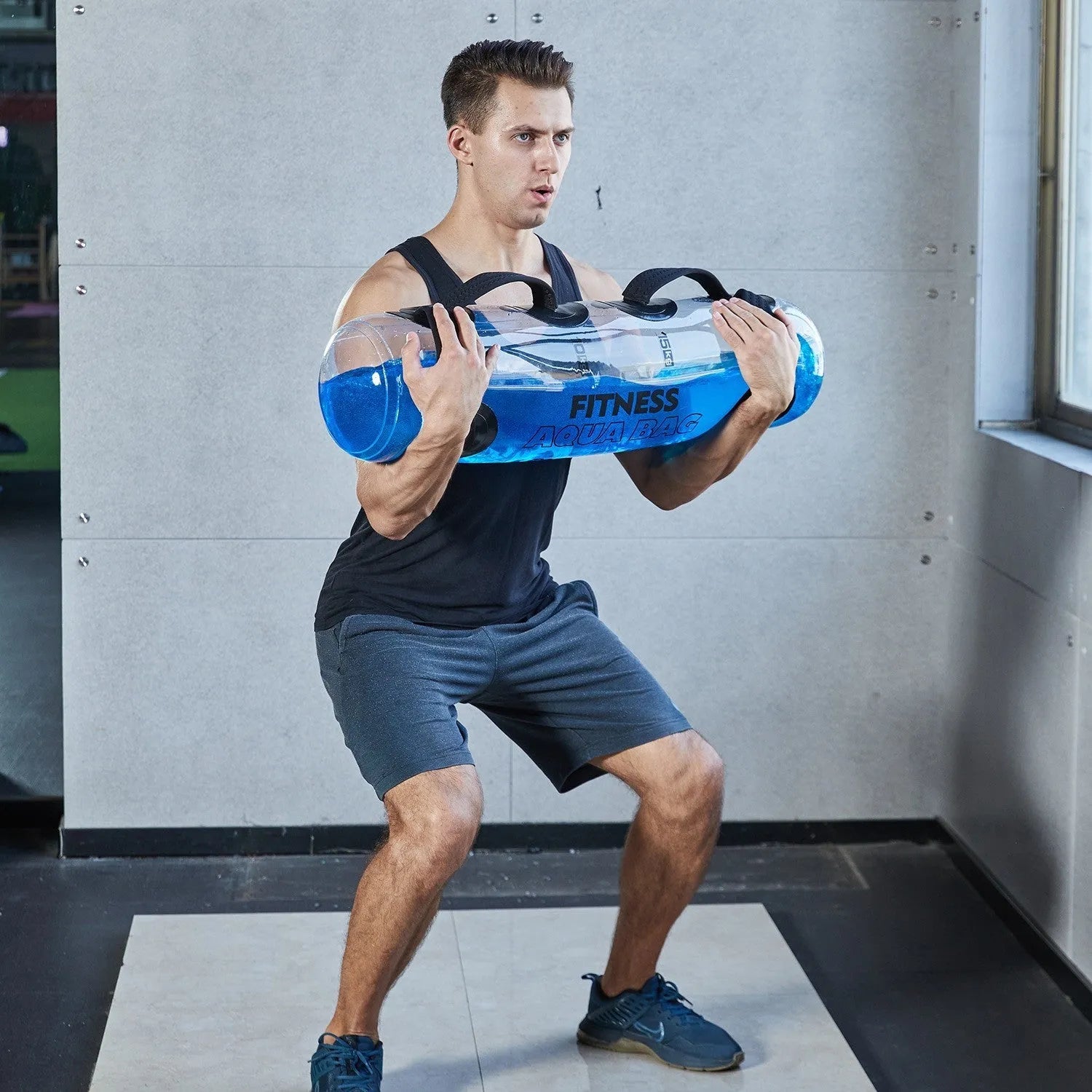 Transparent PVC inflatable water weight bag shown as a soft dumbbell shape for portable strength training.