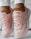Women's white canvas running shoes with round toe and flat heel on solid background