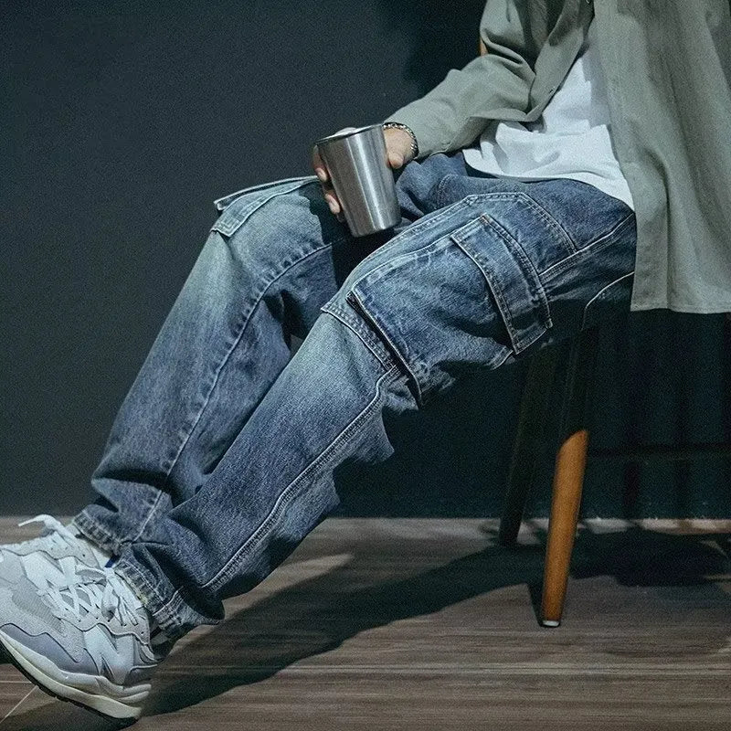 Man wearing blue loose straight-leg stretch denim trousers for a casual retro look.