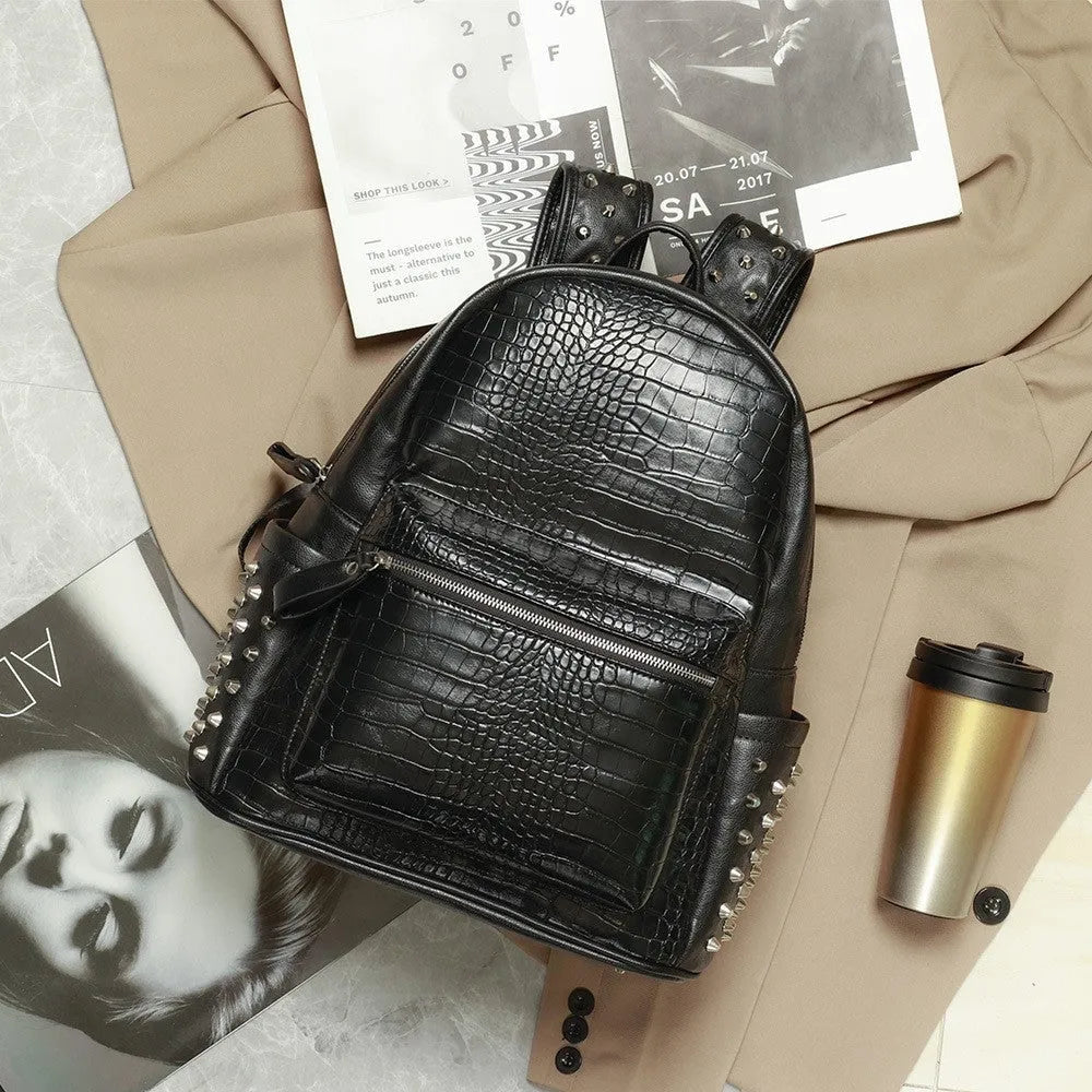 Black waterproof PU oil wax leather computer schoolbag with 36-55L capacity and rivet details.