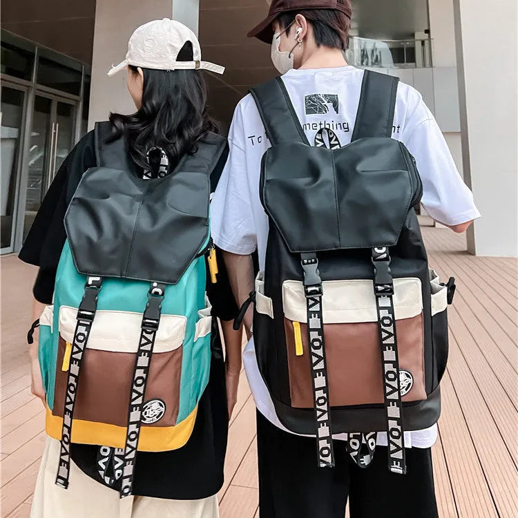 Oxford cloth backpack in black, green, or red colours showing handheld and shoulder straps.