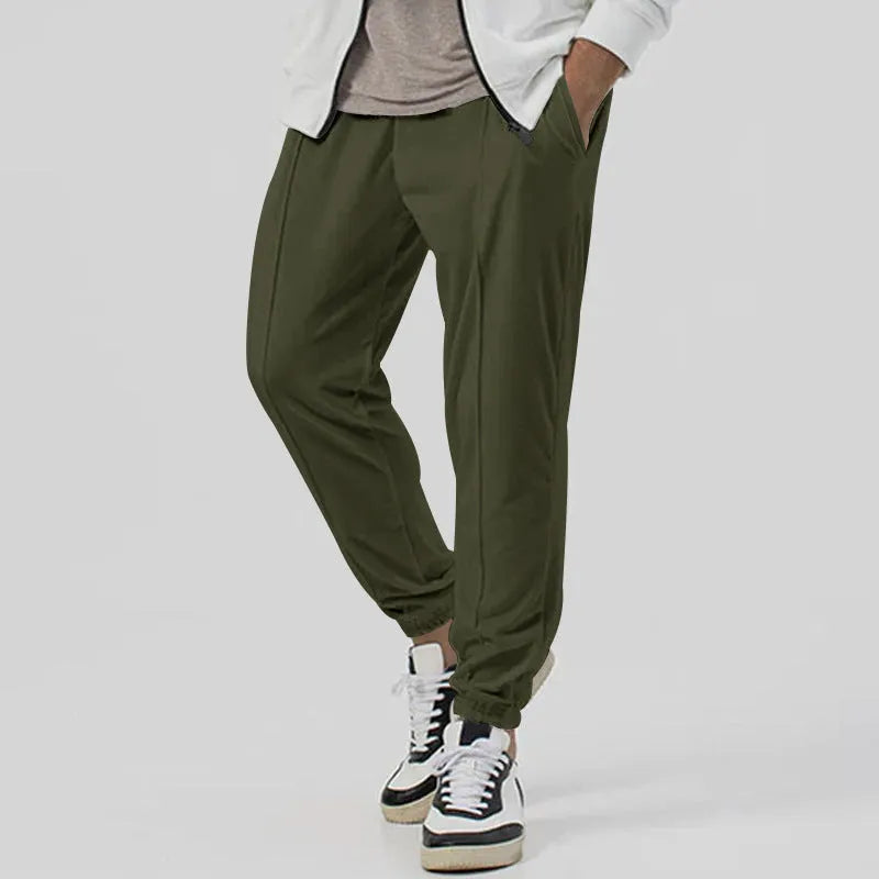 Men's grey cotton blend casual track sweatpants with a tapered leg on a plain background.