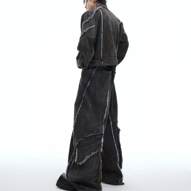 Black gradient distressed denim coat with padded shoulders and matching trousers on a hanger.