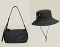 Casual black waterproof nylon messenger bag with single shoulder strap showing interior phone compartment