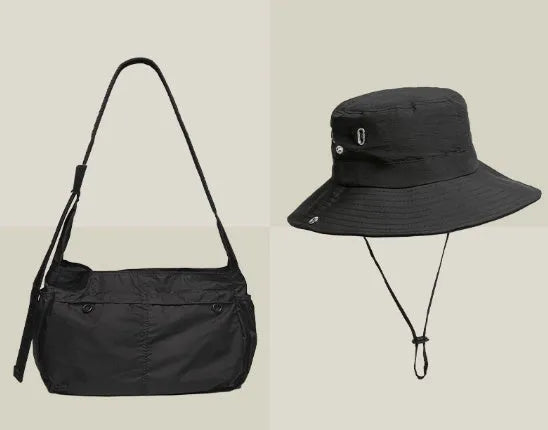 Casual black waterproof nylon messenger bag with single shoulder strap showing interior phone compartment