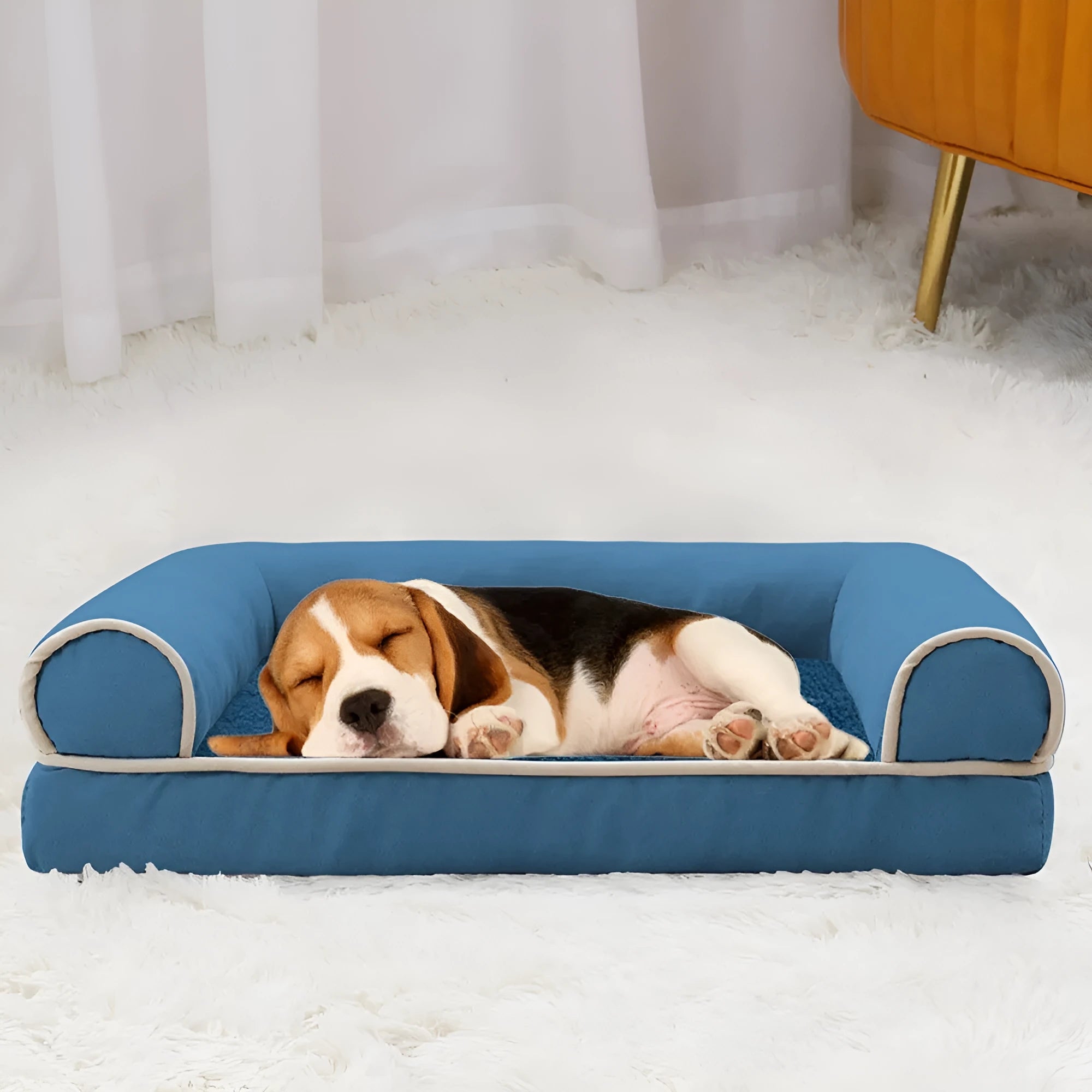 Square blue cloth dog bed with sponge filling on a wooden floor.