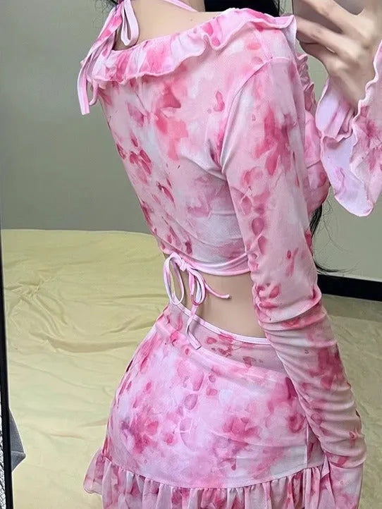Women's cherry blossom pink floral bikini swimsuit laid flat, showing the pattern and style.