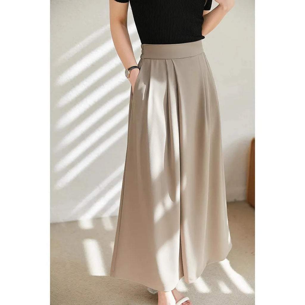 Wide-leg women's trousers in milk apricot with stacked hem design and pockets, flat lay view