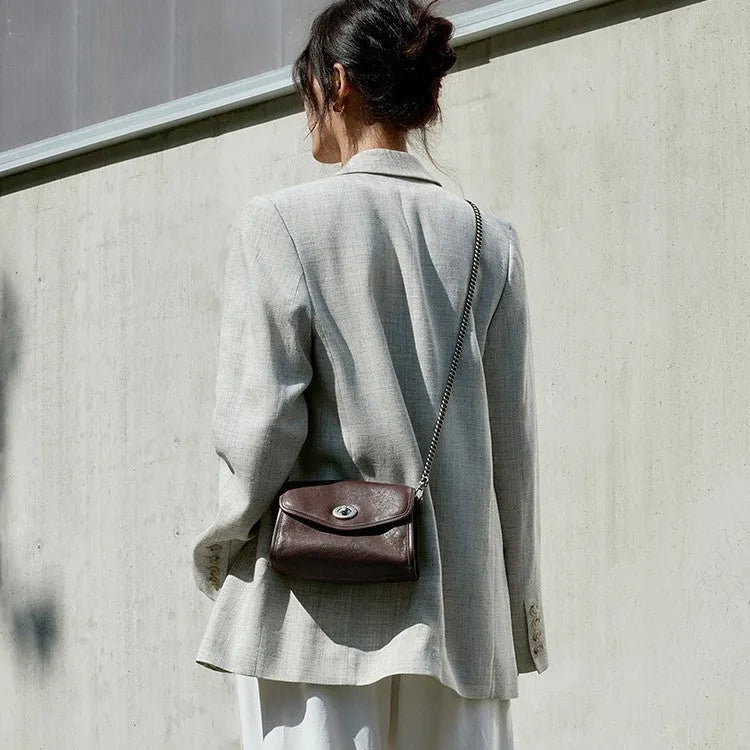 Small genuine leather messenger bag in Black with envelope flap and single shoulder strap