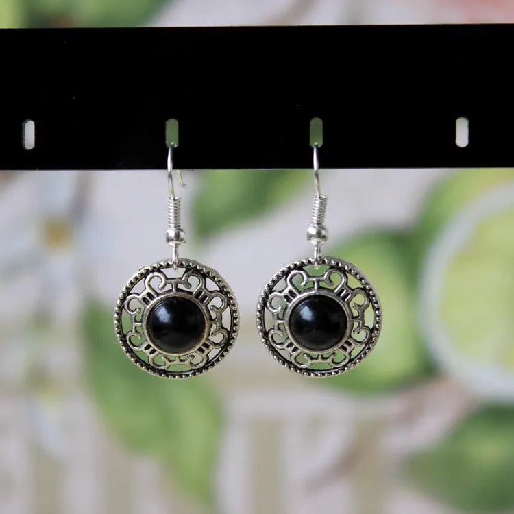 Handmade Miao-inspired silver and turquoise geometric flower disk earrings in black, blue, and red.