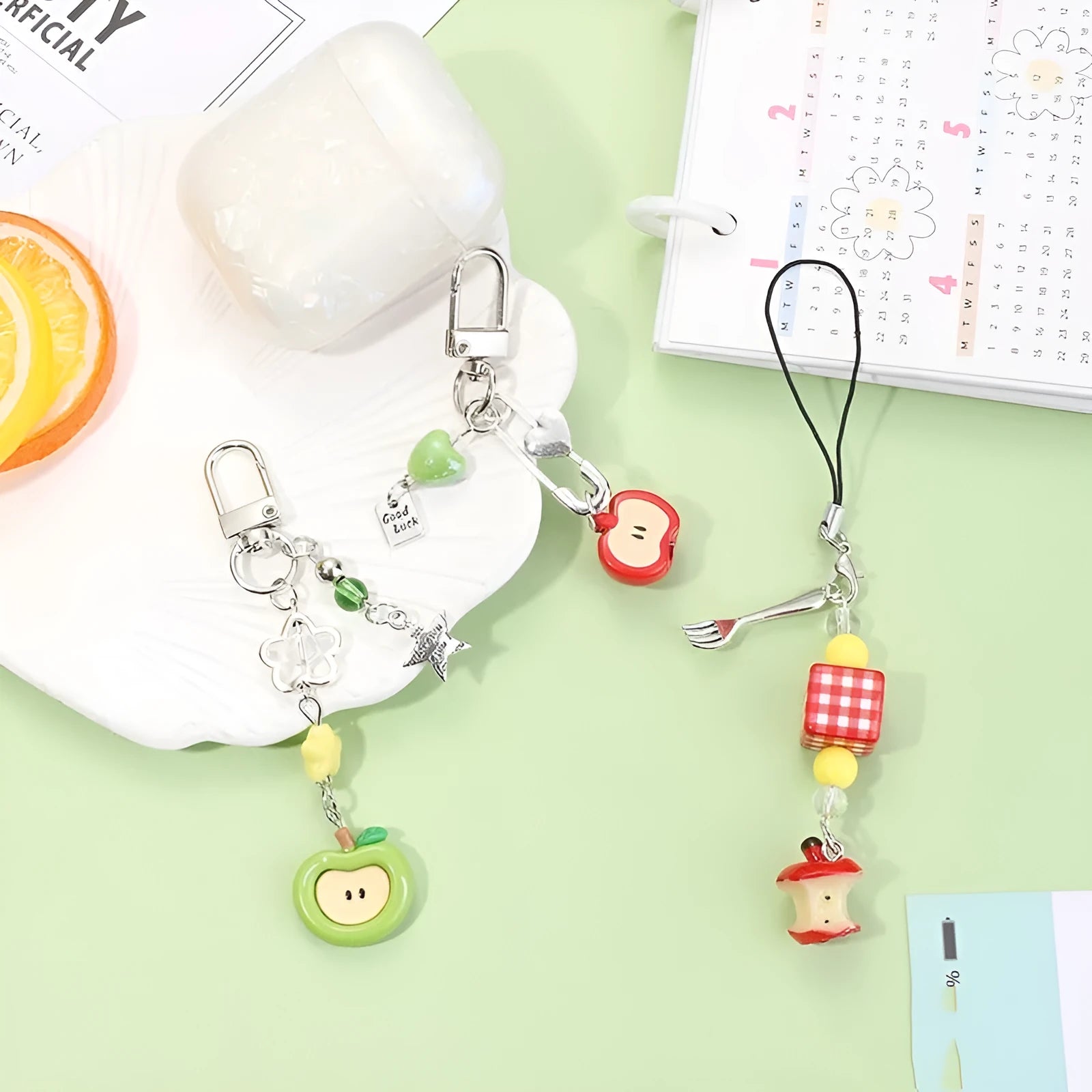 Mobile phone charm keychain with fruit designs including apple and strawberry patterns