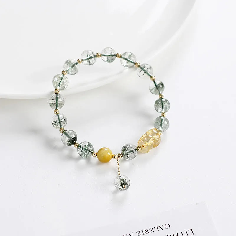 Green phantom quartz crystal bracelet with 8mm geometric beads showing gold rutile inclusions