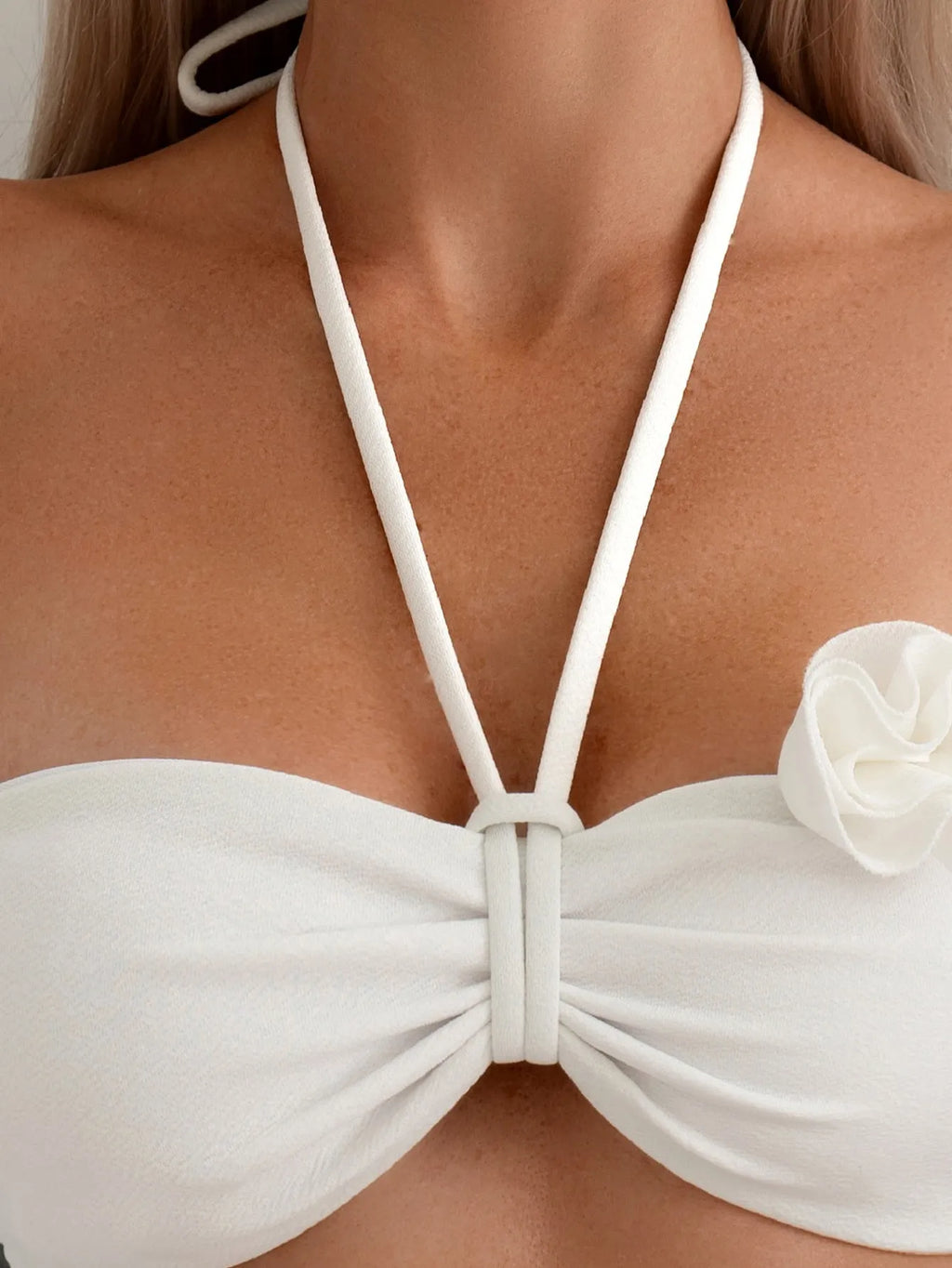 White halter neck lace-up swimsuit with three-dimensional floral details and brief bottom