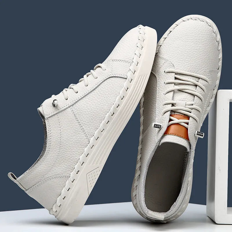 Men's beige cowhide leather casual sneakers with round toe and visible stitching.
