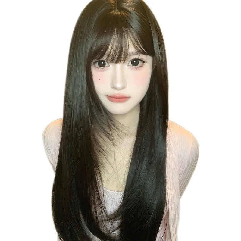 Dark brown long straight synthetic wig with bangs on a wig head.