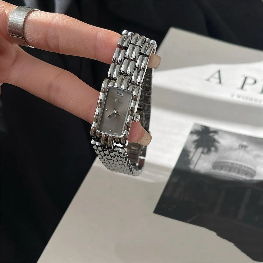 Bracelet-style silver and gold women's Ins watch showing 15mm dial and butterfly clasp.