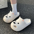 Women's black and white EVA puppy slippers with a toe-cap sandal design on a plain background.
