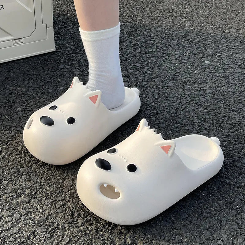 Women's black and white EVA puppy slippers with a toe-cap sandal design on a plain background.