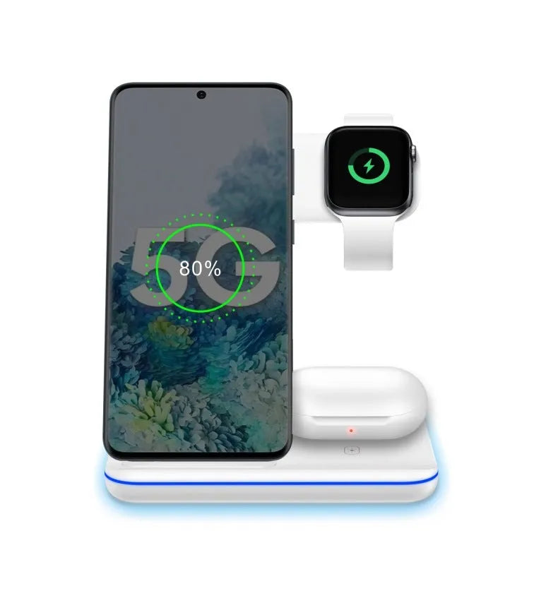 White three-device wireless charging stand on desktop with phone, watch, and headset charging simultaneously